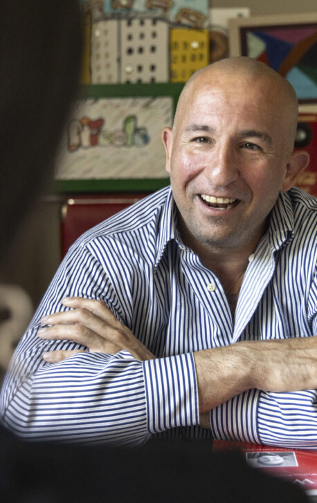 Man in a striped shirt talking with a case manager